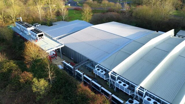 Aerial view of a massive Milton Keynes data center specializing in quantum computing and artificial intelligence infrastructure.