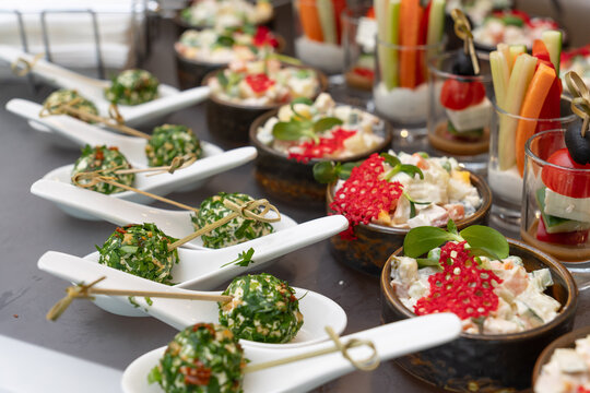 Assorted gourmet appetizers, vegetable sticks, and salads