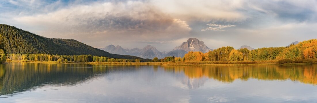 Mount Moran reflected in Snake River, morning mood at Oxbow Bend, autumn trees and Grand Teton Range, Grand Teton National Park, Wyoming, USA