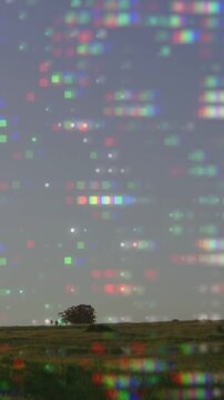 Vertical video: Camera panning right lone tree shifting center pixel grid drifting showing turbines