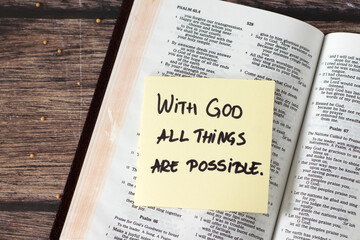 Obraz premium With God all things are possible, inspirational handwritten quote with mustard seeds and holy bible on wooden table. Faith and belief in Jesus Christ, biblical concept.