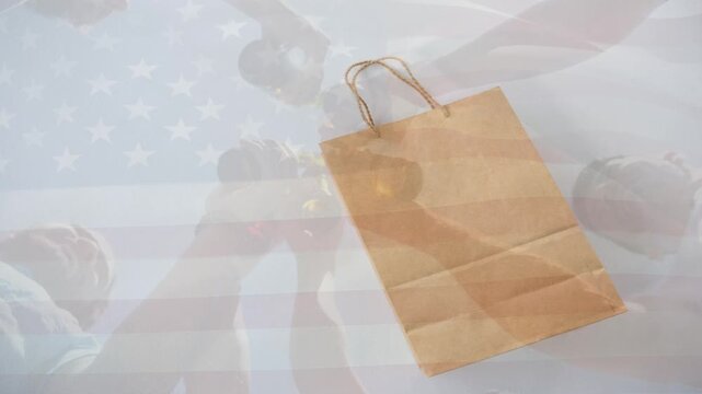 Animation of pink shapes and brown paper bag over blowing flag of america