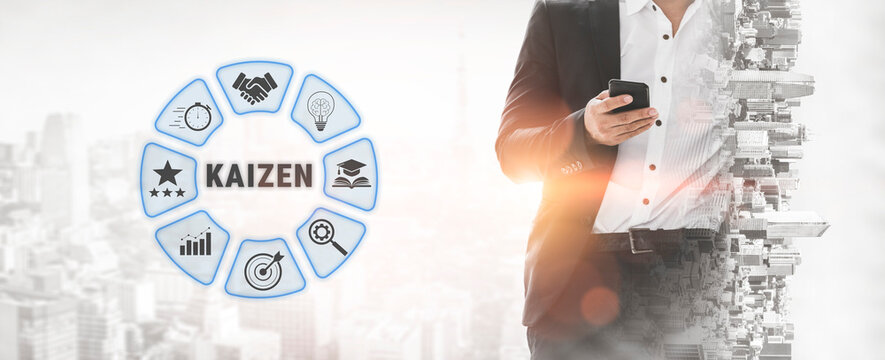 Business professional uses smartphone with Kaizen concept graphic in background, symbolizing continuous improvement and efficiency in workplace settings. Quark.