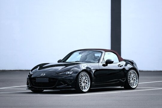 Neu-Ulm, Germany - April, 6, 2026: Black Mazda MX5 ND is parking at the backyard.	