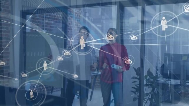 Animation of network of connections with icons over diverse business people in office