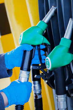 Hand holding a petrol nozzle