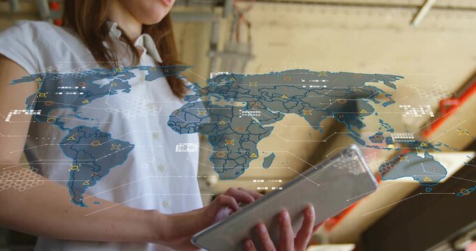 Woman tapping tablet in office starting world map overlay expanding and showing real-time tech data