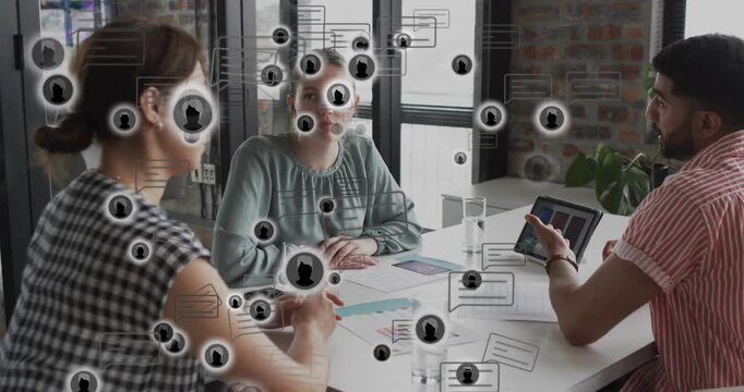 Man starting presentation with tablet explaining graphs, team taking notes, overlay icons drifting