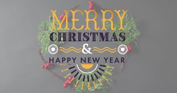 Animation of merry christmas and happy new years text against christmas decorations on grey surface