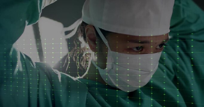 Surgeon preparing for surgery with green heartbeat animation over medical grid