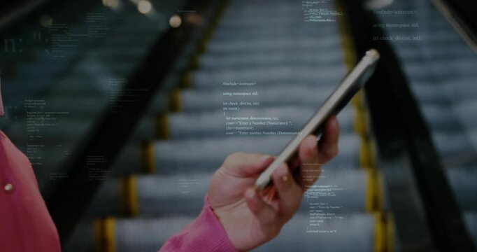 hand holding smartphone capturing escalator, displaying C++ code overlay for technology insight