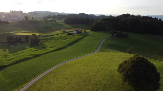 Drone shoot on the Swiss hills of Hirzel with cyclist on path