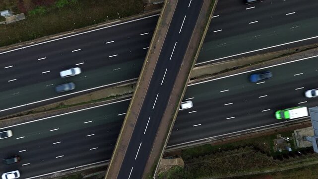 Aerial view of heavy traffic flow on the M1 motorway near Milton Keynes, showcasing a busy British highway and transport infrastructure.