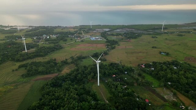 Scenic aerial overview of provincial wind turbines amid lush, tropical island greenery - Guimaras, Visayas, Philippines
