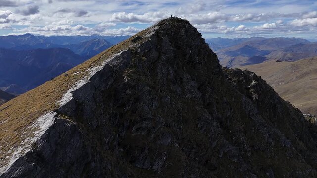 Aerial flight to tourists on Ben Lomond mountain summit in New Zealand