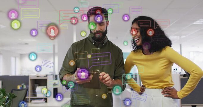 Man tapping tablet while woman reviewing content in business, chat icons and badges getting denser