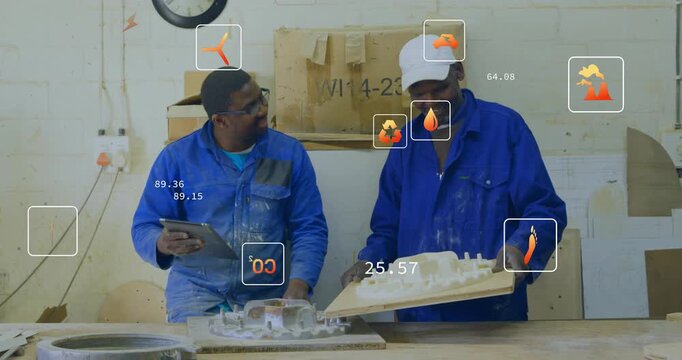 Apprentice tapping tablet while lead tilting model, numeric overlays guiding workshop review