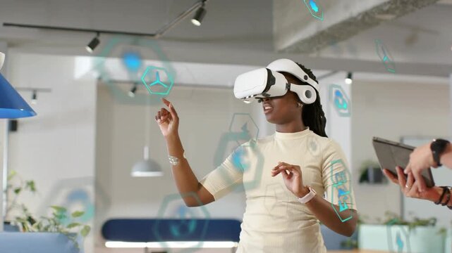 Woman in VR selecting hex icons after UI appearing, man guiding via tablet for tech demo