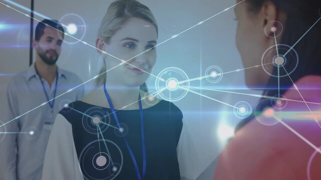 Pink speaker blonde nodding sparking network overlay growing across office showing data on blue IDs