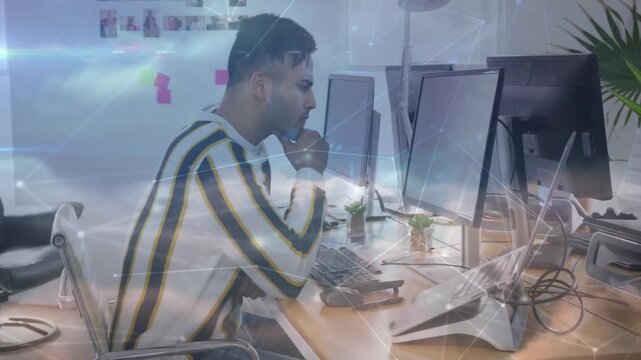 Male developer typing and clicking keys, activating animated network overlay while debugging code