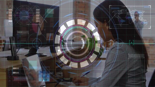 Seated woman writing notes checking laptop as HUD scaling up, enveloping passer for business