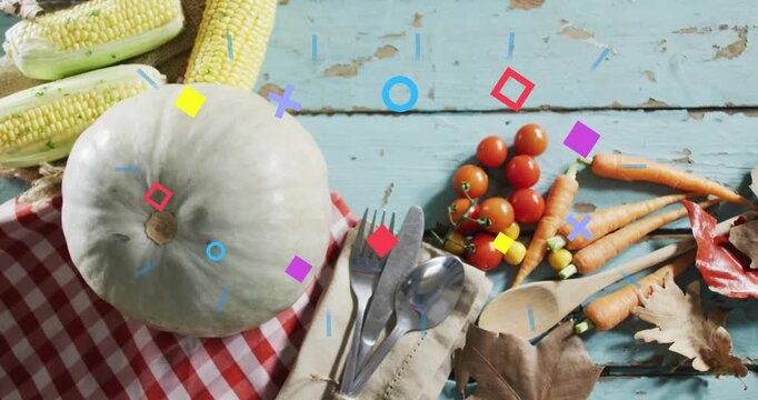 Vertical video: On start pumpkin sitting table with shapes popping fading highlighting fall for ads