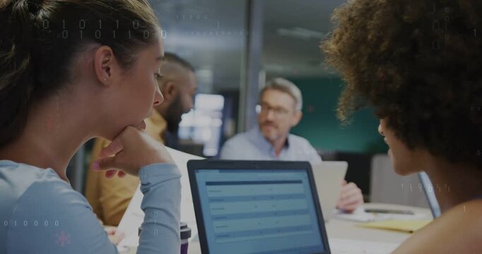 Left woman tapping laptop after right woman pointing rows, HUD flagging table data for business