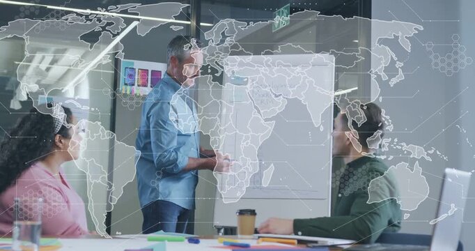 Man starting writing on flipchart in business meeting, clarifying plan, world map overlay growing