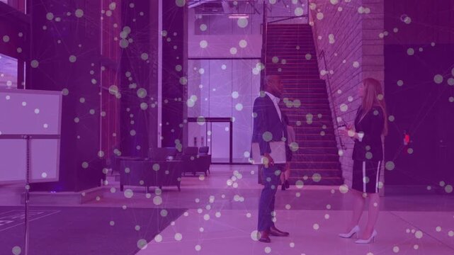 Woman turning tablet toward man, starting doc checking and gesturing in biz lobby purple overlay