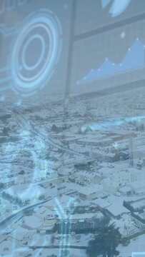 Vertical video: Snow roofs via glass reflecting pulsing HUD and chart after slight drift to monitor