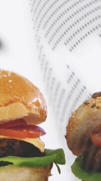 Vertical video: Dot sweeping in overlaying burgers, cam panning and centering them for food ad