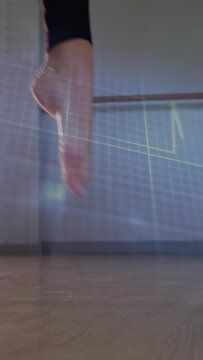 Vertical video: Dancer shifting, rolling and rising, crossing foot while grid traces path for dance