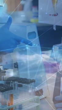 Vertical video: Lab tech placing tube into vortex, pipetting samples for testing with cloud overlay