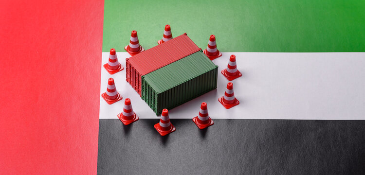 The cargo container ban on the uae flag as a conceptual backdrop. The cargo container embargo