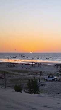 Perfect golden hour at Jericoacoara with kitesurfers, Ceara, Brazil.