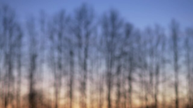 Drone rising upward with bright lights before leaving twilight frame