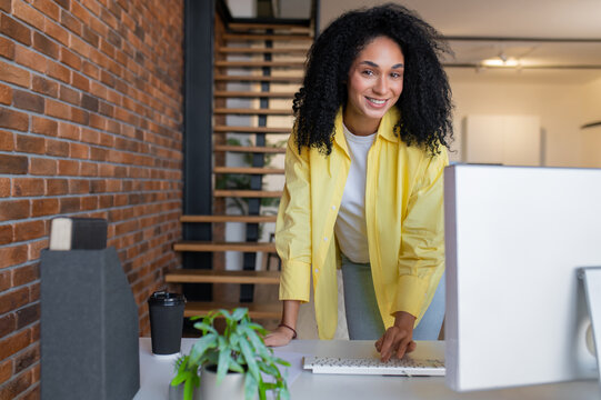 Young long-haired self-employed woman working from home and looking busy