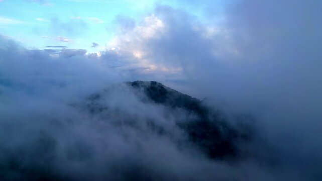 Aerial shot highlights Pulau Pangkor, misty forest canopy glowing under soft sunrise light.