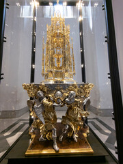 Fototapeta premium Intricate golden sculpture displayed in a glass case.. Toledo Cathedral, Spain