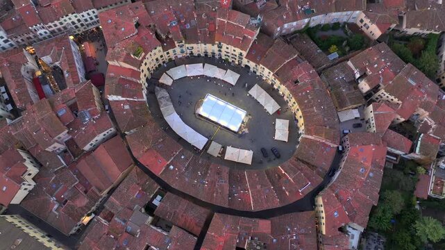 Aerial view of the main square, Piazza dell'Anfiteatro, in Lucca, Tuscany, Italy. Medieval Historical Center at Twilight
