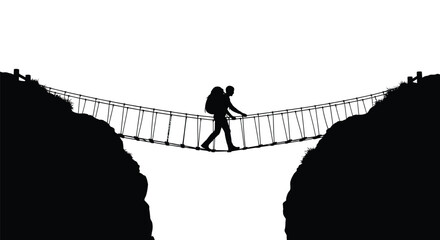 Obraz premium A lone hiker crosses a rope suspension bridge between two rocky hills silhouette