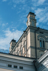 Obraz premium Historic architectural towers rise dramatically against a blue sky