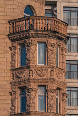 Warm golden light illuminates detailed carvings on classical building turret © Дмитро Ганжеєв