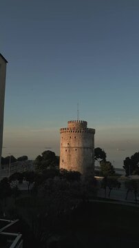 Cinematic 60fps vertical shot of Lefkos Pyrgos landmark in Thessaloniki during golden hour.