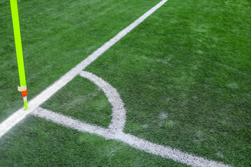 soccer field with green grass, white markings, and a corner flag.. The image captures part of the pitch used in professional matches, highlighting sports atmosphere and game preparation © Point of view