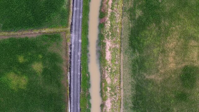 Drone overhead view Labuh Banting rice paddy canal road