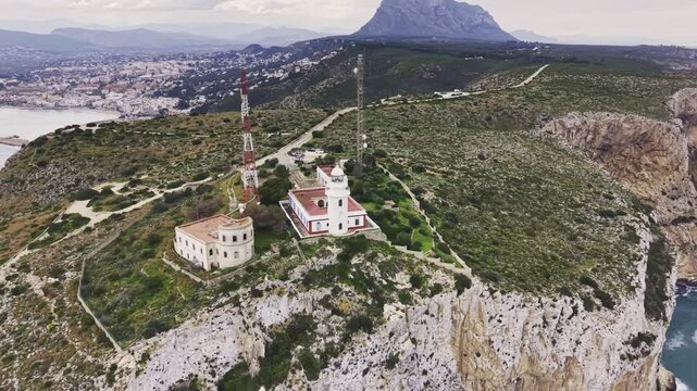 Aerial view of Cape Sant Antoni lighthouse on a cliff in Javea, Spain