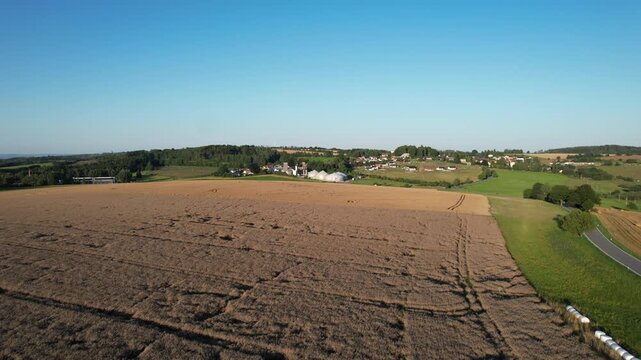Aerial view of agricultural complex of barns and biogas production domes and storage tanks, bio renewable energy generation from rural panorama landscape Europe