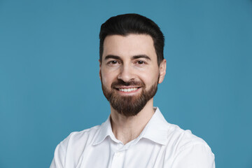 Obraz premium Portrait of handsome man on light blue background
