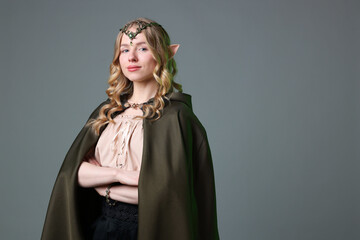 Obraz premium Beautiful elf girl on grey background, space for text